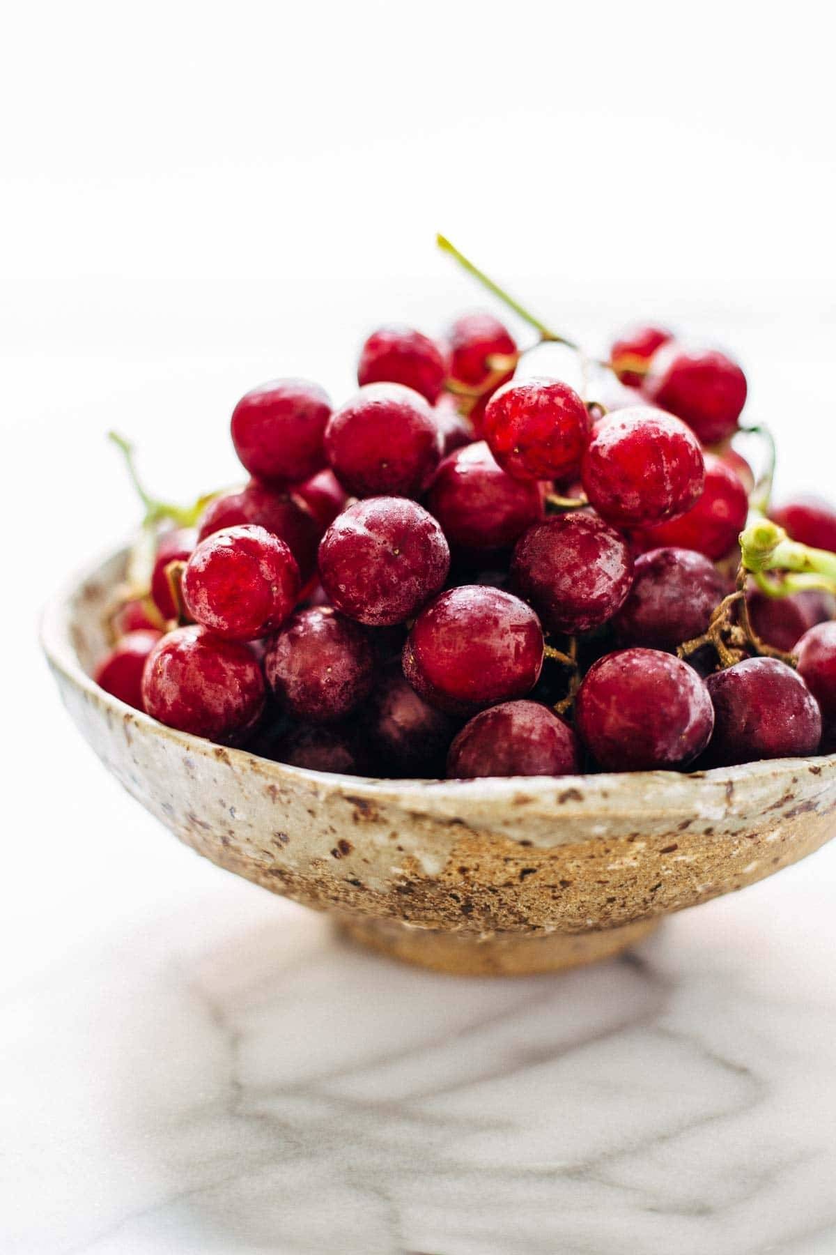 This Arugula Salad has grapes, cashews, pickled red onions, and a simple black pepper vinaigrette. Vegan, vegetarian, gluten free. | pinchofyum.com