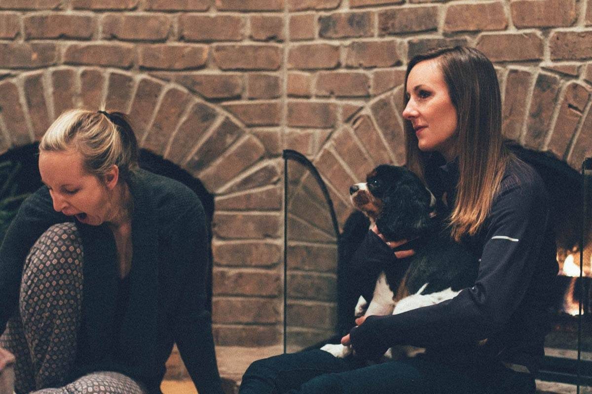 People sitting by a fireplace.