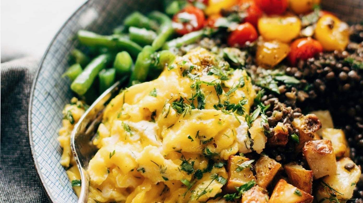 Lentil Bowl with scrambled eggs, potatoes, green beans, and tomatoes.