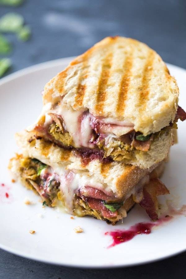 Loaded Turkey Panini cut in half on a plate