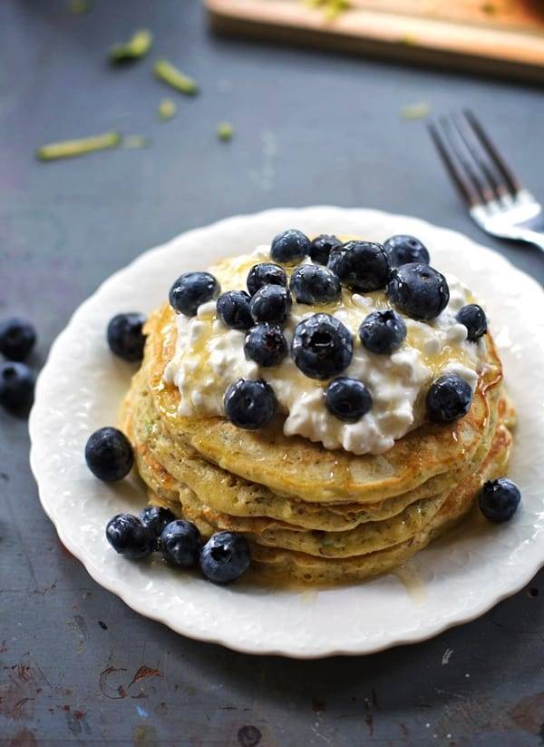 Stack of zucchini pancakes with blueberries.