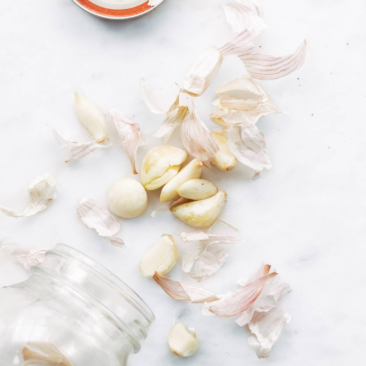 Cut garlic on a white surface.