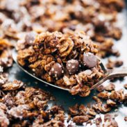 Spoonful of Chocolate Granola on a baking sheet.