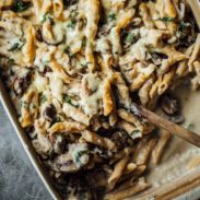 Mushroom Alfredo Pasta Bake in a pan with a spoon.