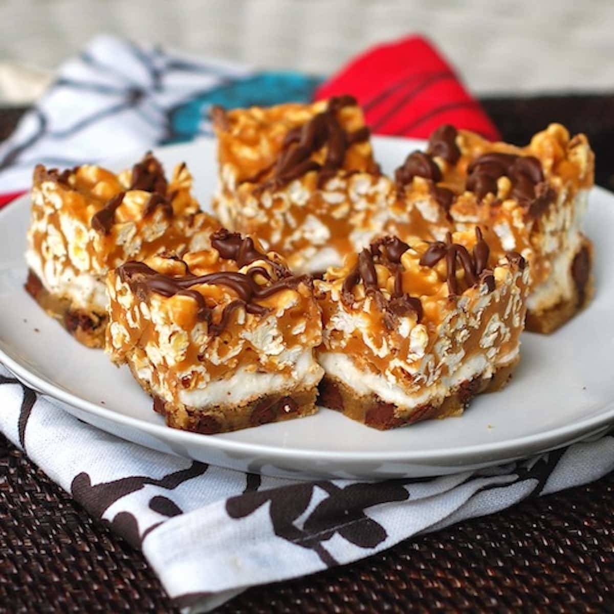Caramel corn bars with a marshmallow caramel corn topping, drizzled with chocolate.