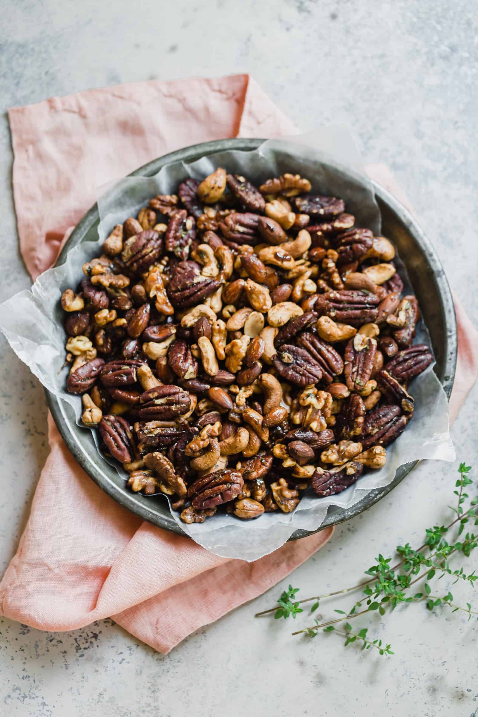 Spiced nuts in a bowl with wax paper